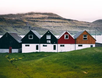 horizontal-view-colourful-farmhouses-coast-green-grass-ground